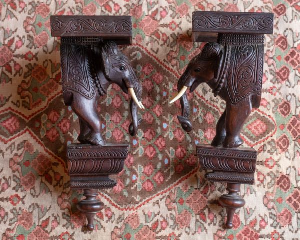 A very fine pair of C19th carved elephant shelves in superb condition. Carved in a hardwood and with ivory tusks . Really quite exceptional.