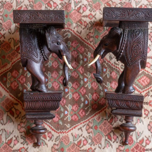 A very fine pair of C19th carved elephant shelves in superb condition. Carved in a hardwood and with ivory tusks . Really quite exceptional.